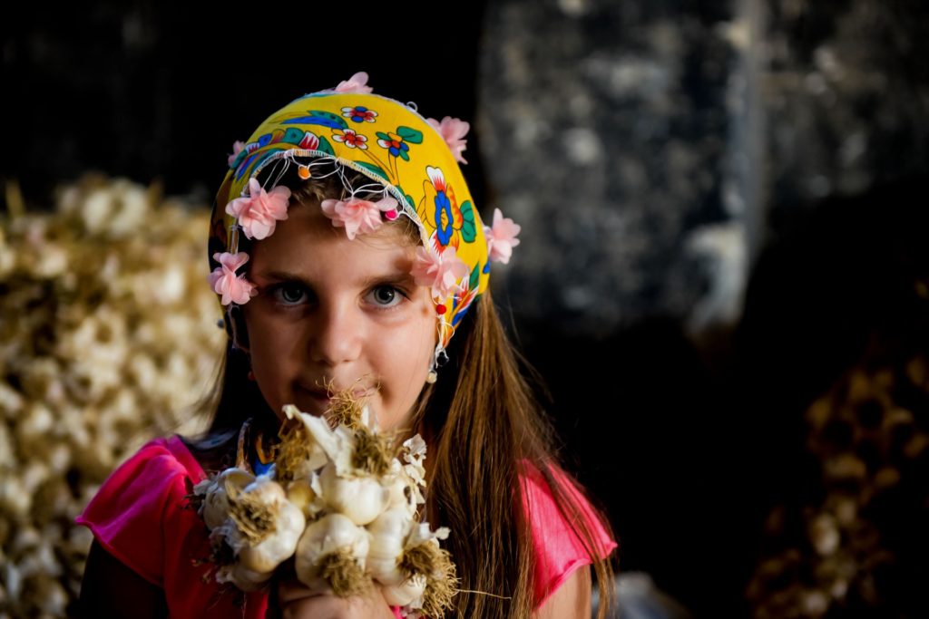 Girl gives garlic, 
Reasons Why You Should Consume Black Garlic